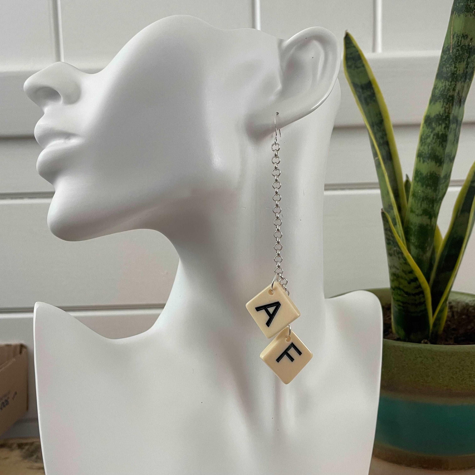 AF Long Statement Earrings 4.75" Letter Game Tile Cream Resin Repurposed Upcycled Fun Game OOAK, displayed on a solid white mannequin