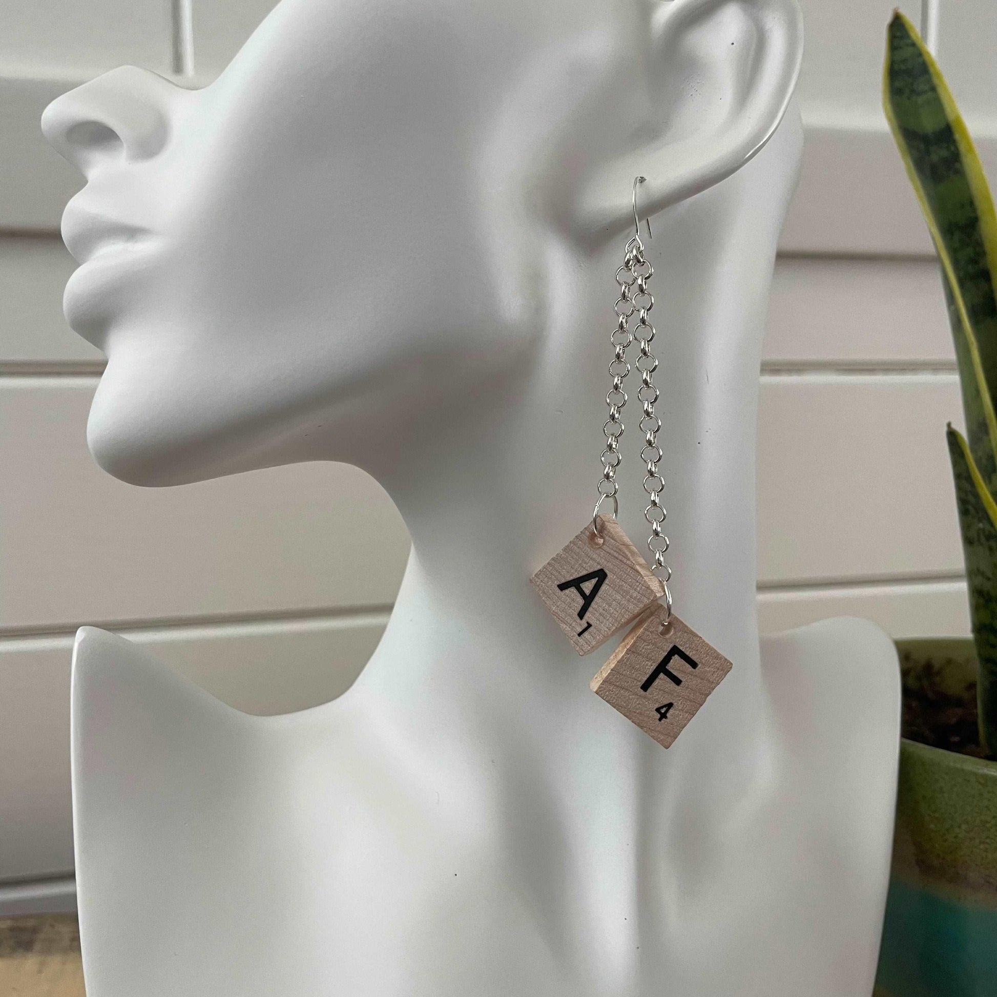 AF Long Statement Dangle Earrings 4" Scrabble Tile Tan Wood Repurposed Upcycled Fun Game OOAK, displayed against solid white mannequin head