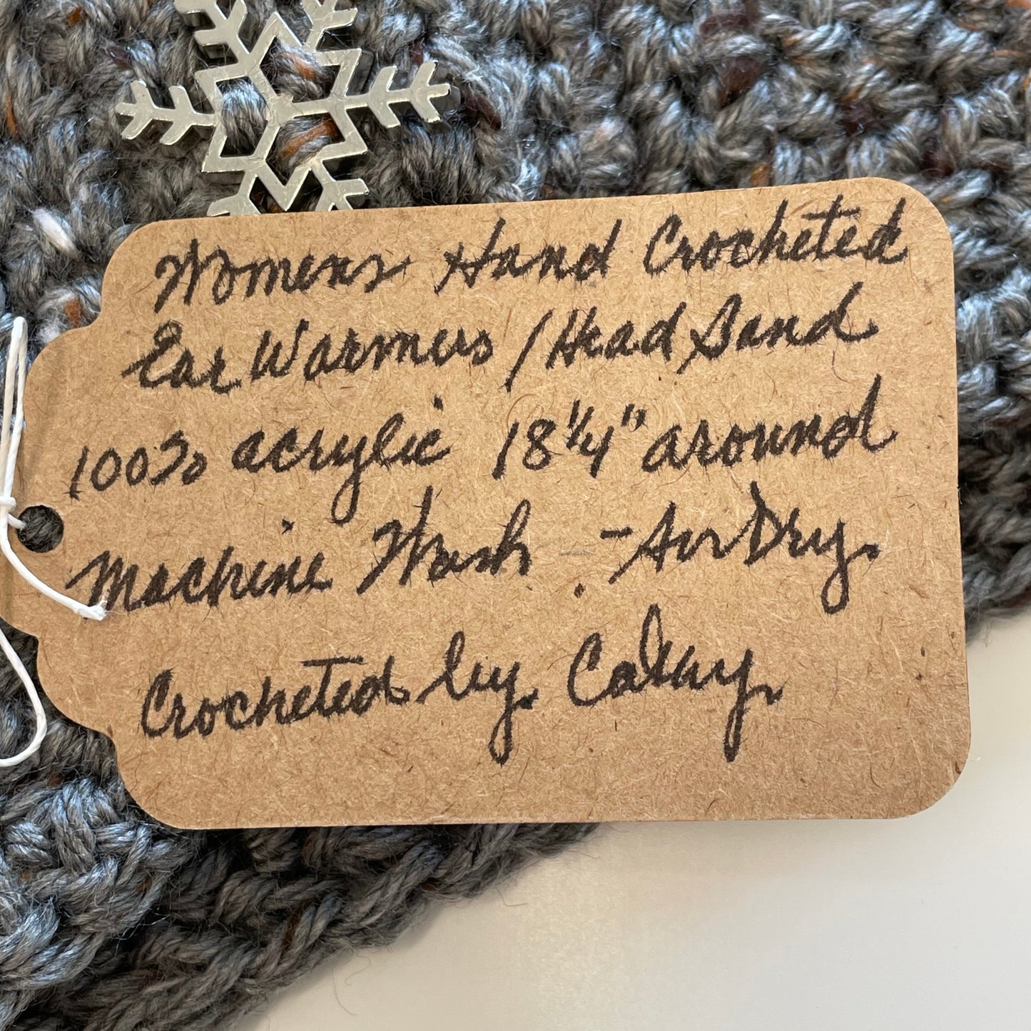 close up of handwritten ear warmer tag--details in description.