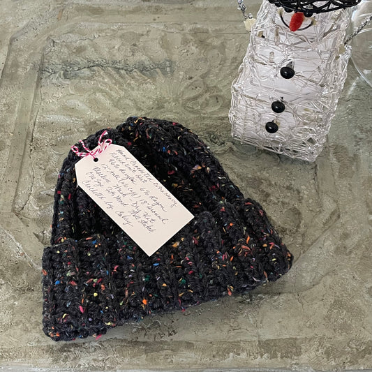 Extra Warm Ribbed Cable Knit Hat Charcoal Black & Speckled Rainbow Hand Crocheted Beanie Winter Unisex Outdoor Stretch Adjustable Cuff--displayed flat on stone background
