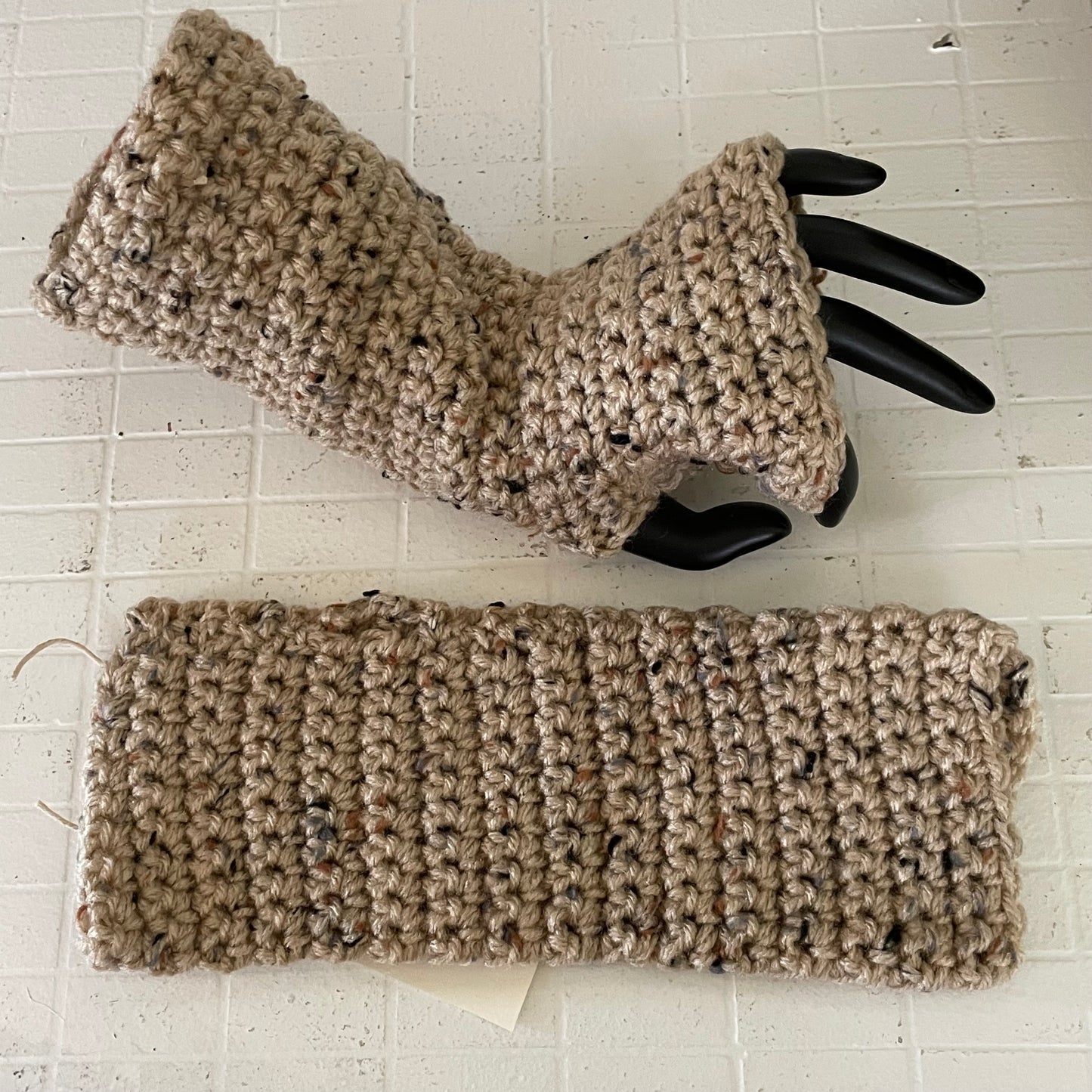 Narrow Dark Speckled Wheat Tweed Tech Wrist Warmers Crochet Knit Spring Fall Winter Gaming Fingerless Gloves Small Teen 1 displayed on mannequin hand, 1 displayed flat