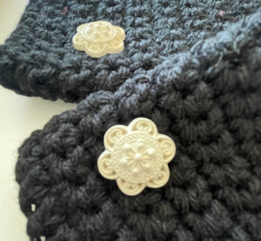 close up photo of ivory cream textured flower button