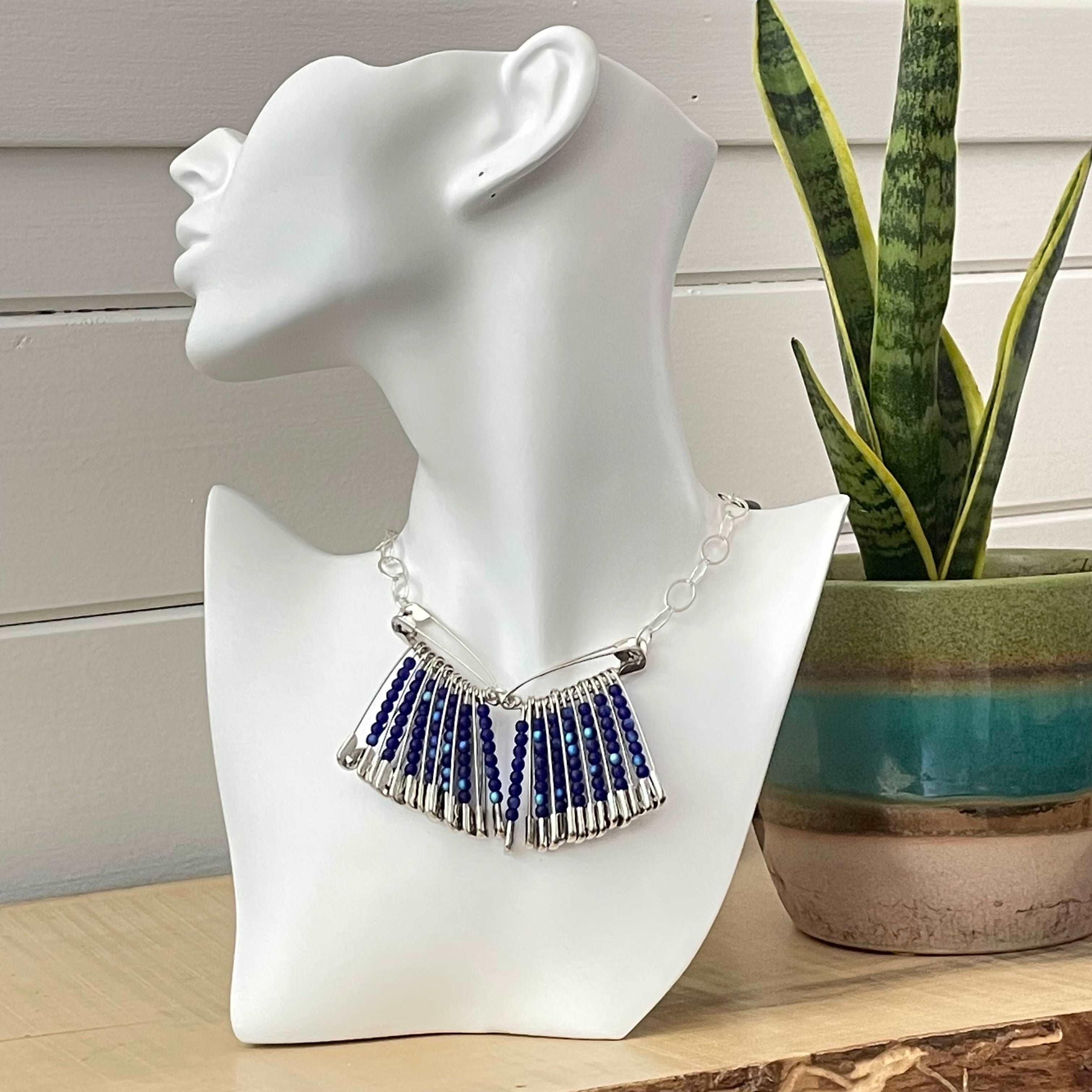 Blue Glass Bead & Safety Pin Statement Necklace 22" Chain Punk Rock Avant Garde Upcycle Repurposed displayed on mannequin