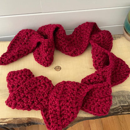 Extra Warm Crochet Knit Chunky Ruffled Scarf Hand Crafted Marbled Red Wine Maroon Metallic Accent Flirty Fall Winter--featured on a natural light wood table