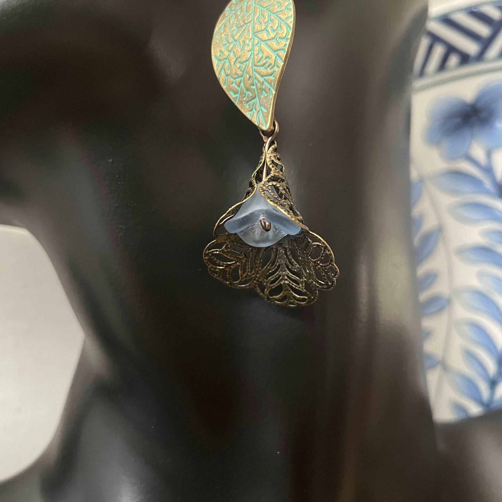 Antiqued Brass Leaf & Pastel Blue Flower Earrings 3" Abstract Peacock--closeup pf blue glass flower bead