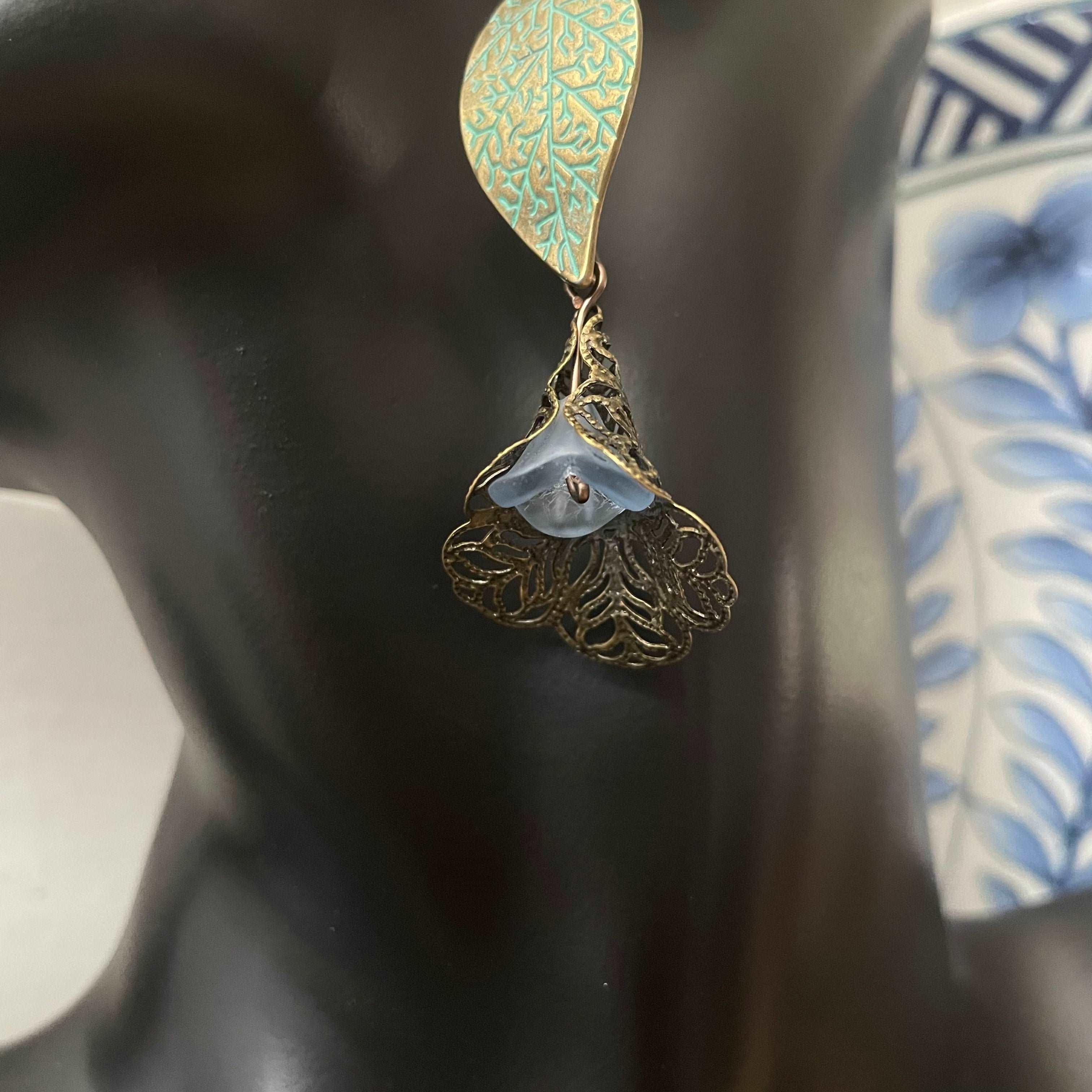 Antiqued Brass Leaf & Pastel Blue Flower Earrings 3" Abstract Peacock--closeup pf blue glass flower bead