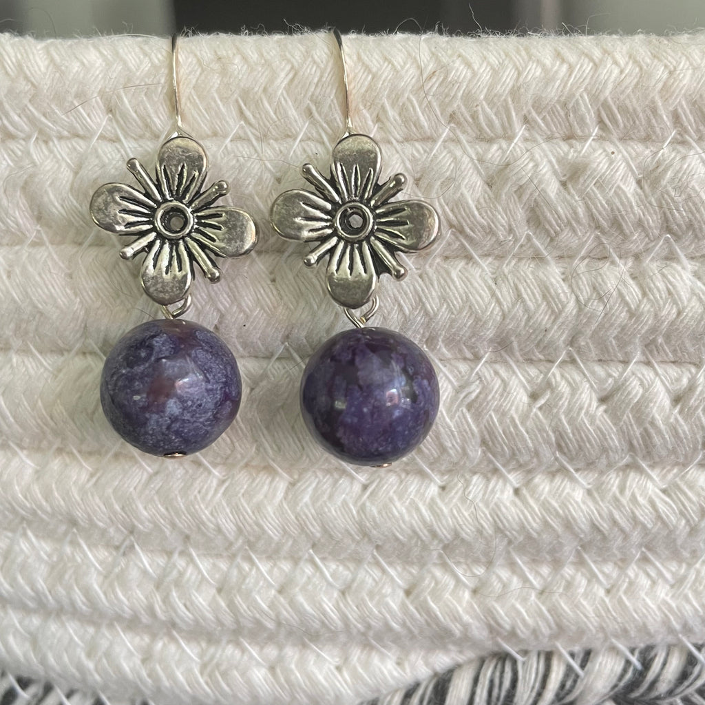 Antiqued Flower & Dark Purple Marbled Jasper Drop Earrings 1.5" close up against ivory woven textile