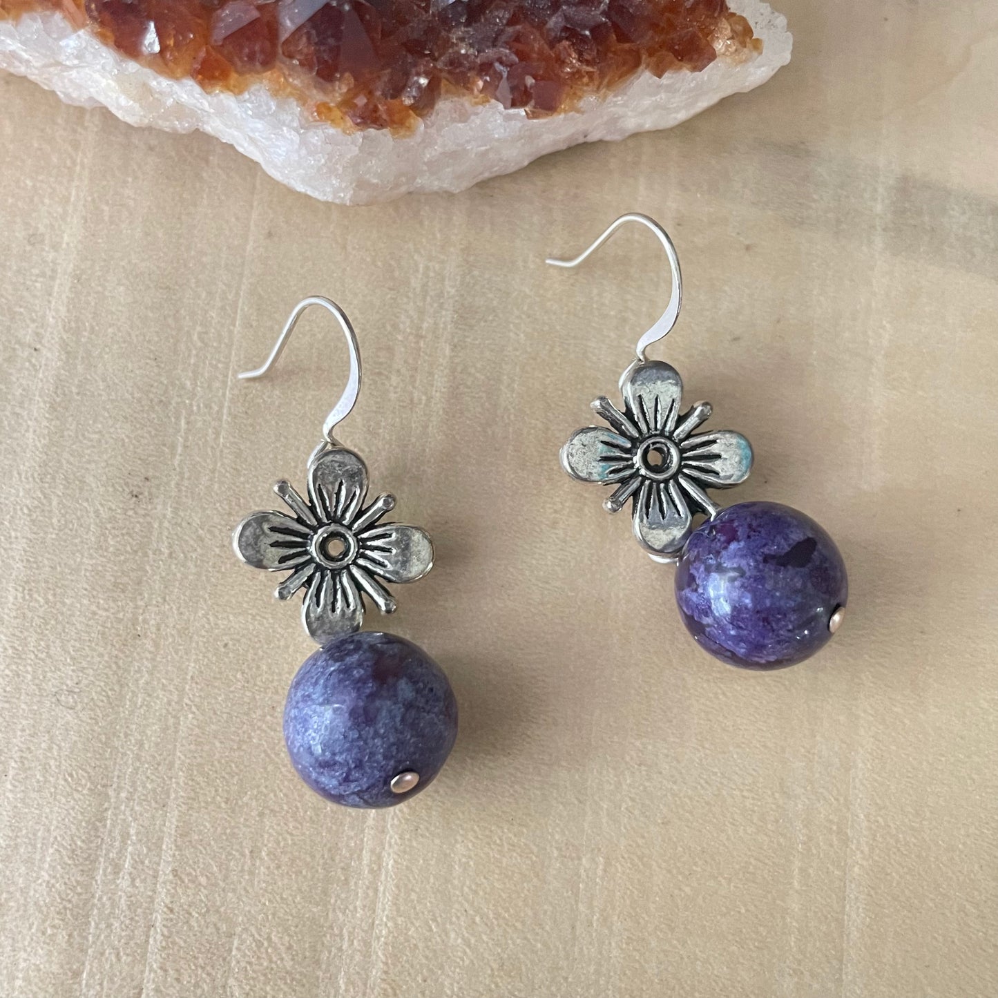 Antiqued Flower & Dark Purple Marbled Jasper Drop Earrings 1.5" close-up against light tan wood background