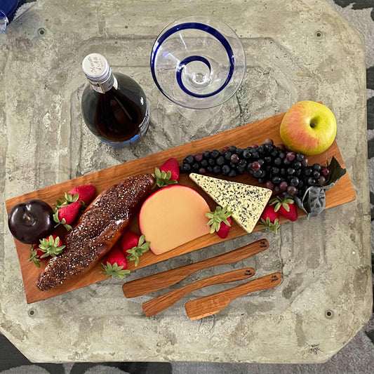 4 Piece Charcuterie Gift Set Handmade Live Edge White Oak Wood Long Snacking Board & 3 Utensils--displayed with fruit and next to wine