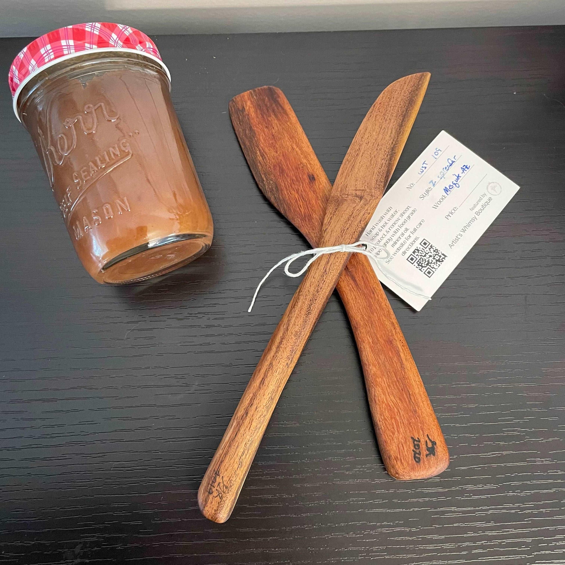 2 Piece Set Handmade Wooden Kitchen Utensil Set, Mesquite displayed next to jam jar
